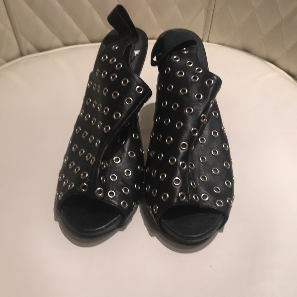 Black platform sandals with silver circle details.